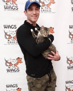 young man adopt a cat WAGS