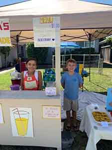 Maya and CJ prepped for their lemonade and dog biscuit stand WAGS