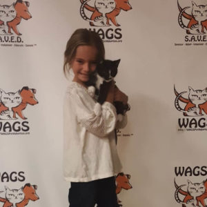adorable kid adopt a cat at WAGS