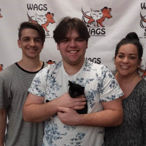 group smile with new adopted black kitten