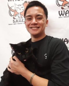 man with black shirt adopted black cat