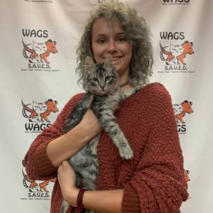 curly woman with maroon jacket adopted sweet streak coat cat gray